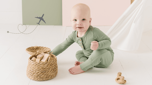 Baby Playing With Blocks In Woven Basket Wearing Bamboo Jogger Set in Fern