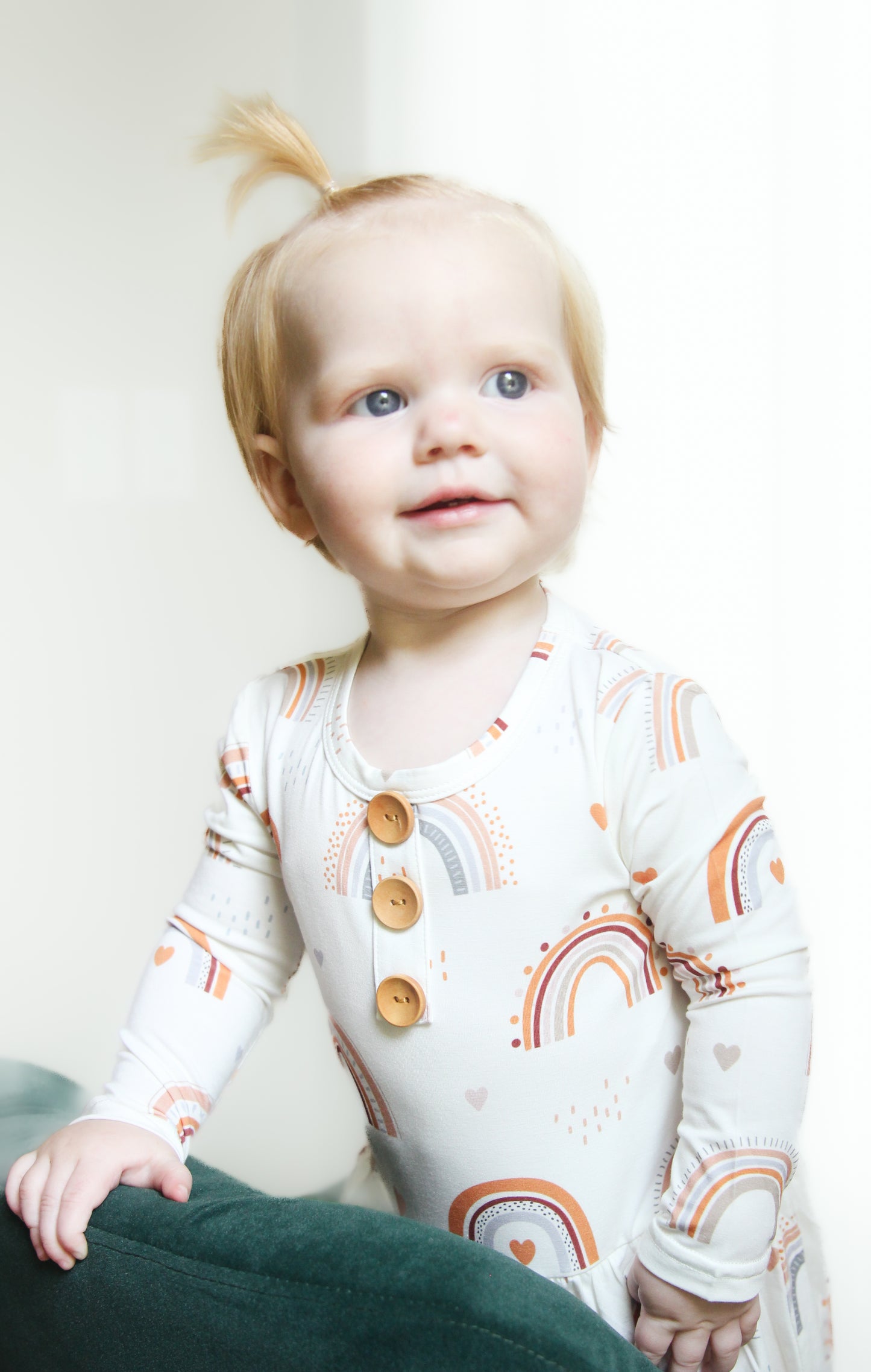 Toddler Wearing Luna Luz Rainbow Onesie Dress